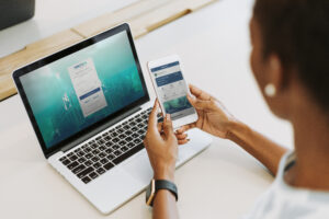 Woman using laptop and smartphone